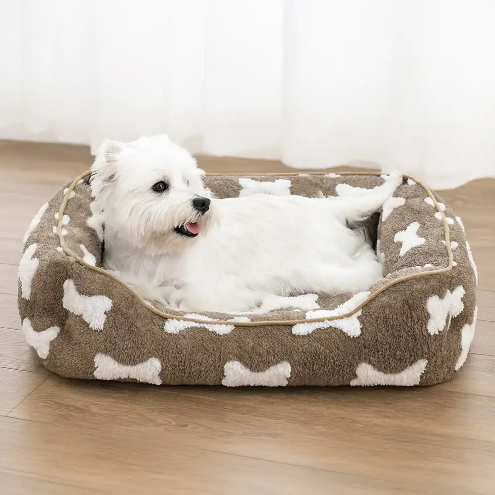 Cama para perros cuadrada de felpa con patrón de hueso y profundidad para dormir