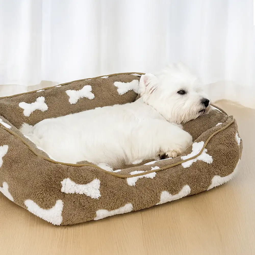 Cama para perros cuadrada de felpa con patrón de hueso y profundidad para dormir