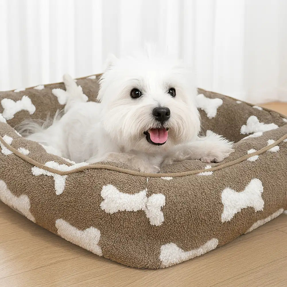 Cama para perros cuadrada de felpa con patrón de hueso y profundidad para dormir