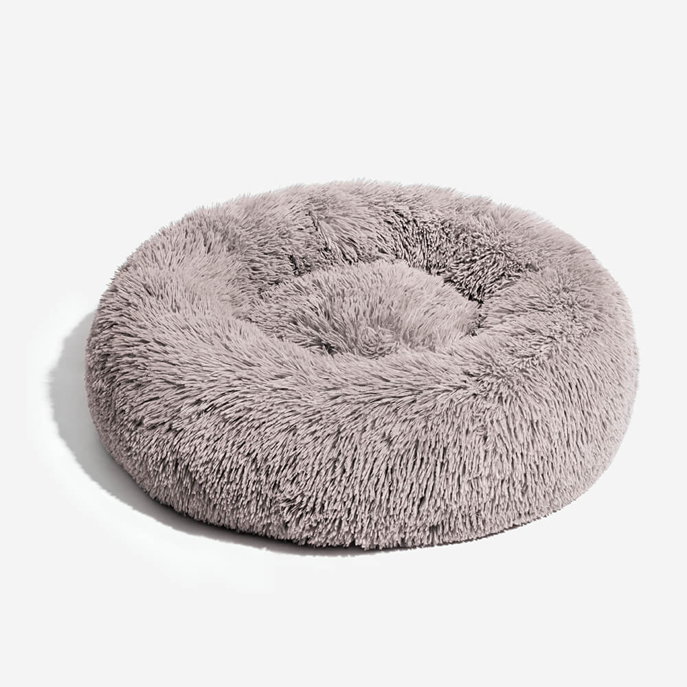 Cama de perro esponjosa redonda y borrosa