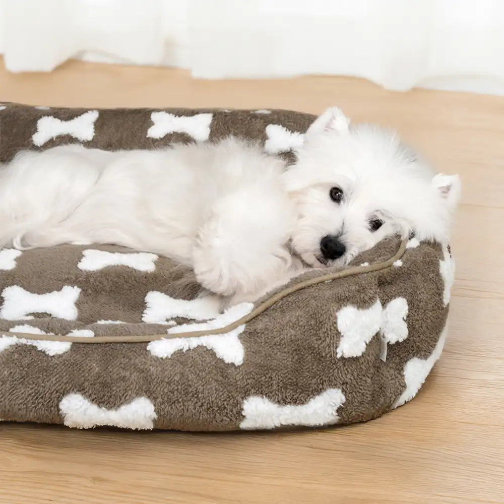 Cama para perros cuadrada de felpa con patrón de hueso y profundidad para dormir
