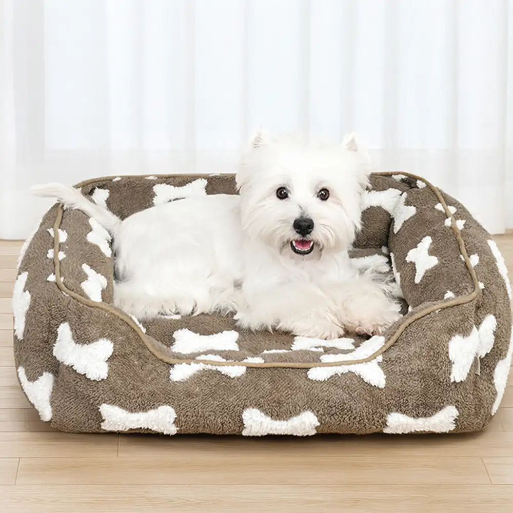Cama para perros cuadrada de felpa con patrón de hueso y profundidad para dormir